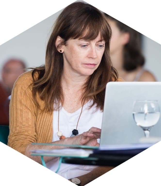 A business owner working on her laptop at a 25eight session