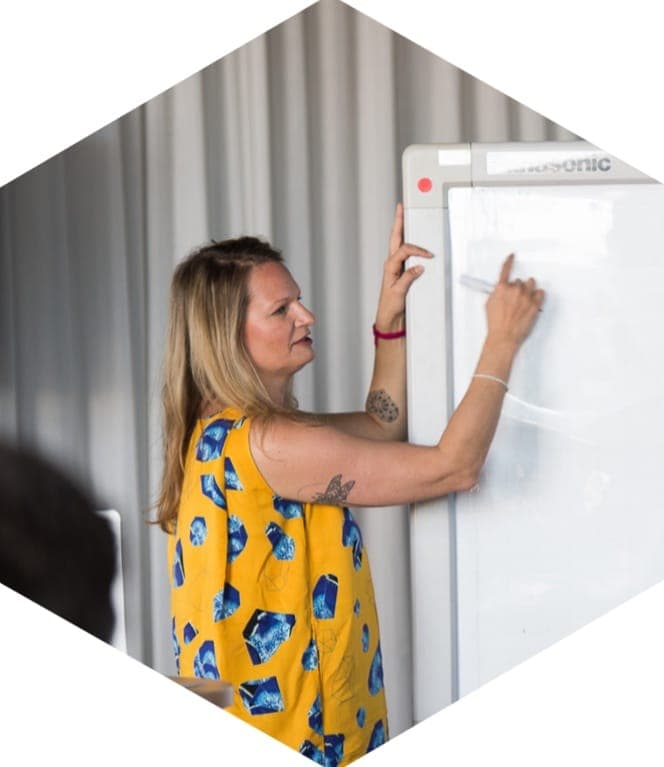 Sam Hurley mapping a business system on a whiteboard