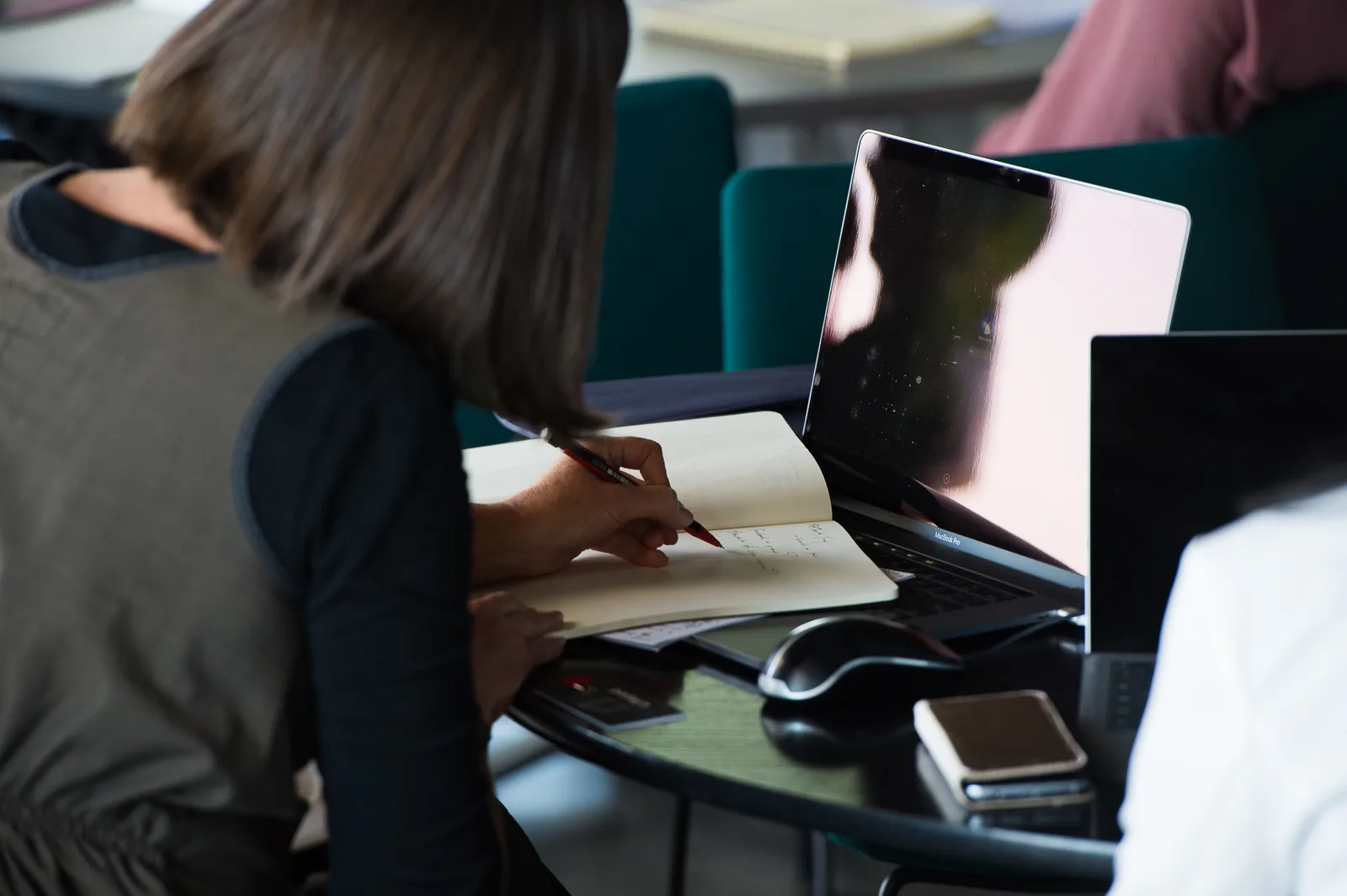 An owner working through the program with notes and a laptop